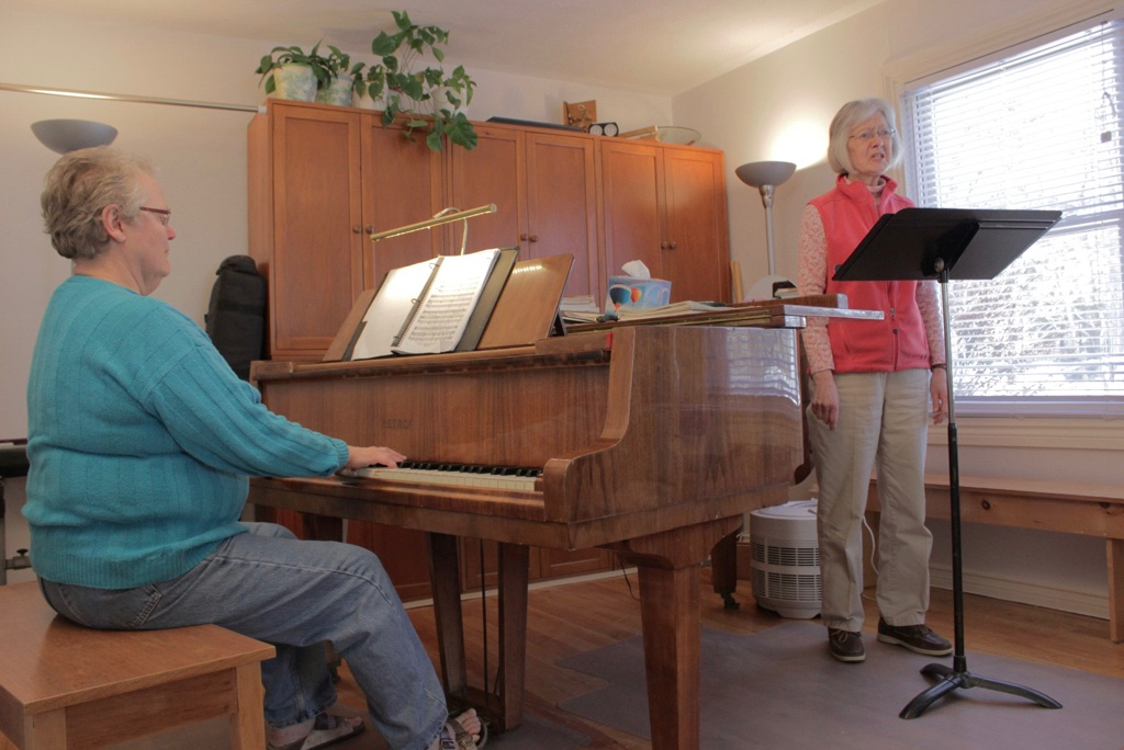 Ruth playing a duet with one of her students, Karon